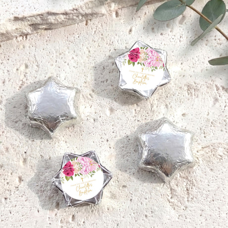 Foil-covered chocolate stars with floral personalized label, silver foil shapes