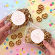 Personalised First Holy Communion pretzel bags with pink cross sticker and pretzels