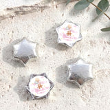 Silver star-shaped foil balloons with 'Charlotte's Baby Shower' teddy design