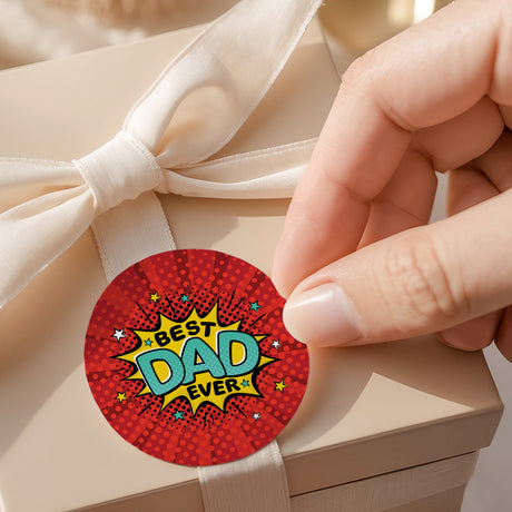 Red round printed label: “Best Dad Ever” with star accents on white ribbon.