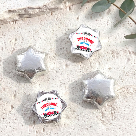 Silver foil-covered chocolate star sweets with personalized "THEODORE" label