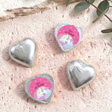Silver foil chocolate hearts with unicorn “Zara’s 6th Birthday” label.