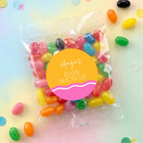 Personalised baby shower jelly bean bag with wavy pink/orange label and colorful candies