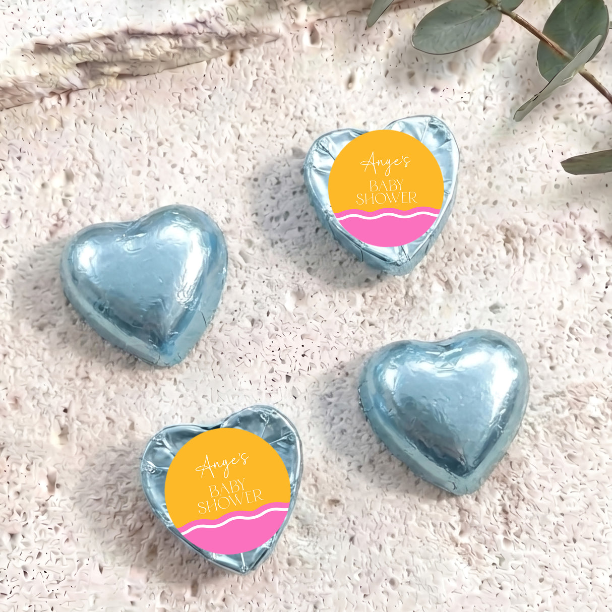 Light blue foil heart chocolates with “Ange’s Baby Shower” label, wavy pink-orange stripe