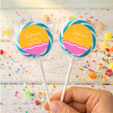 Personalised 40th birthday lollipops with blue-wrapped sticks and yellow-pink round labels
