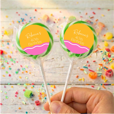 Personalised 40th birthday lollipops with green-wrapped sticks and yellow-pink round labels