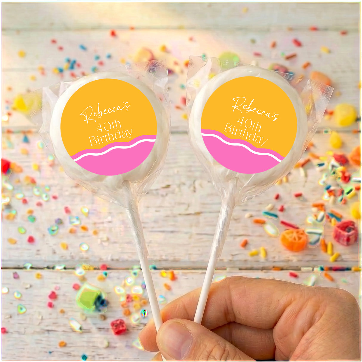 Personalised 40th birthday lollipops with clear wrappers and yellow-pink round labels