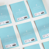 Light blue printed chocolate wrappers with cross, handwritten-style prayer text, and barcode.