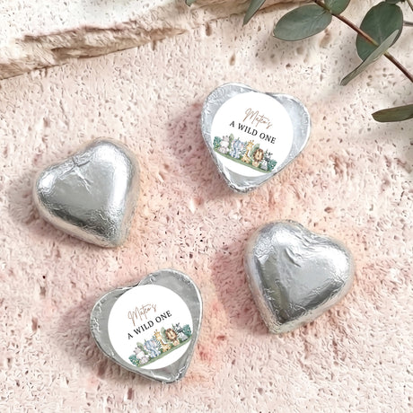 Silver foil-covered chocolate hearts with white labels reading “A WILD ONE”.