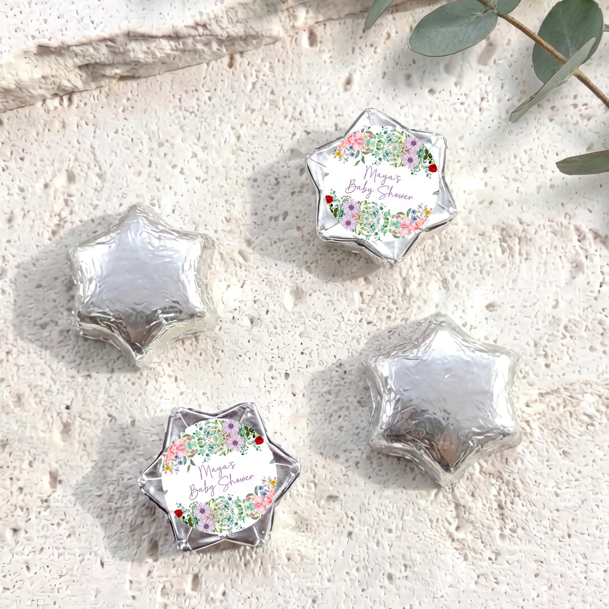 Personalised foil-covered chocolate stars, silver foil set with floral label