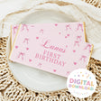 Pink chocolate bar wrapper with bows, hearts, and 'Luna's First Birthday'