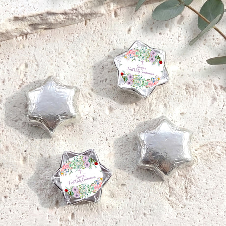 Silver foil-covered First Holy Communion chocolate stars with floral personalised labels