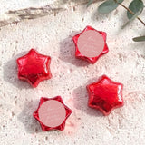Set of red foil-covered chocolate stars with a pink heart label