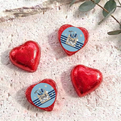 Red foil-covered chocolate heart chocolates with “Dad” label on each
