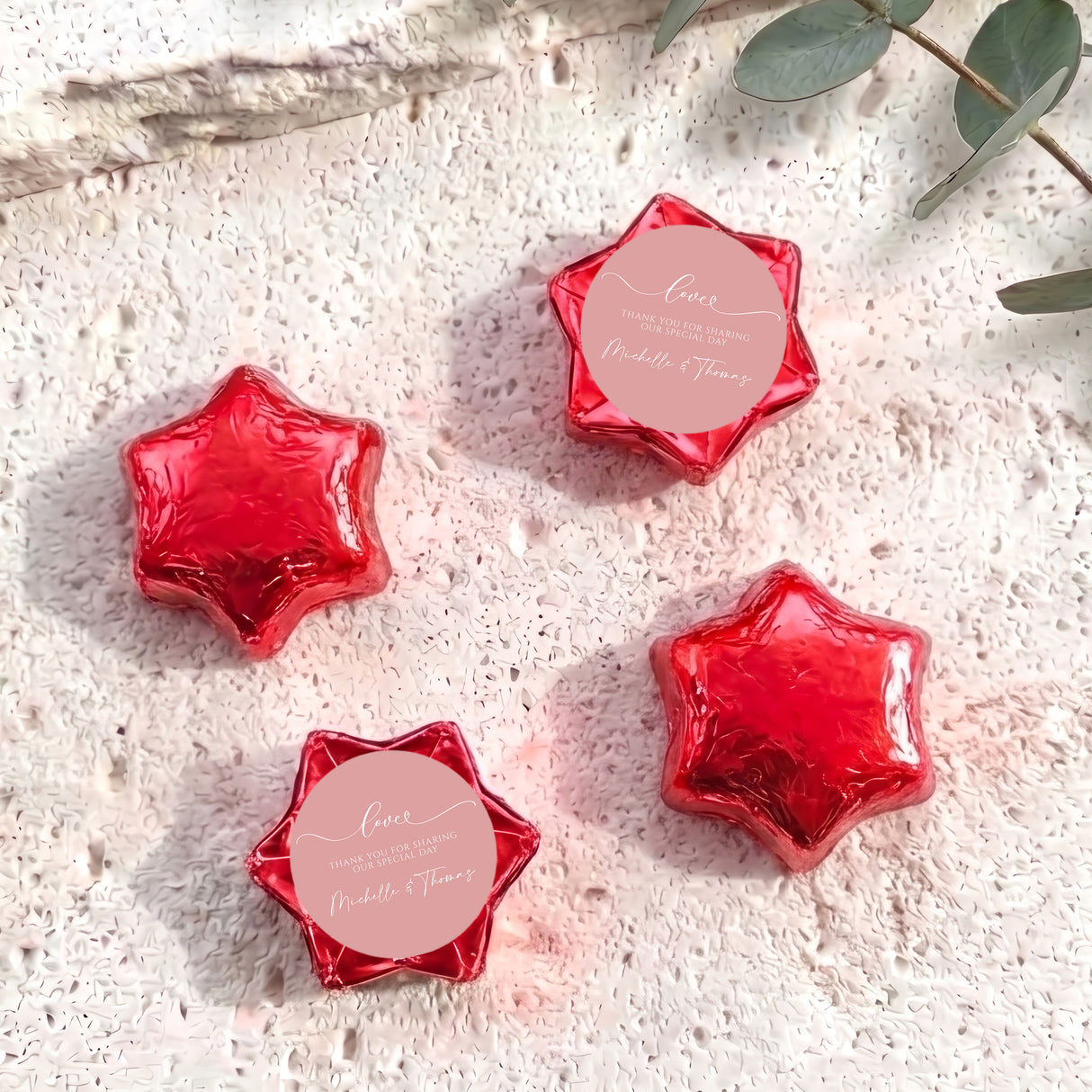 Red foil-covered chocolate stars, star-shaped foil chocolates with round label.