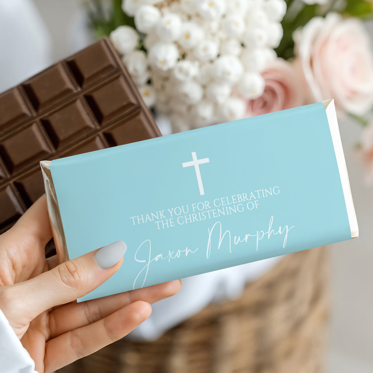 Light blue christening chocolate bar wrapper with white cross and custom name text