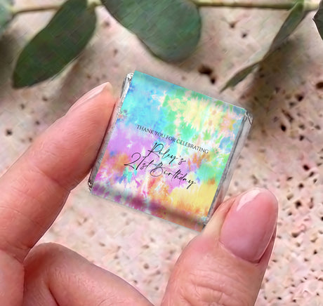 Single mini tie-dye wrapped chocolate with birthday personalised message, held close-up