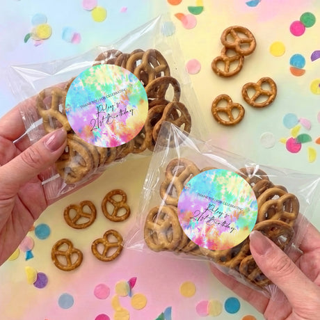 Tie-dye pretzel gift bag with clear wrap and round colorful birthday label