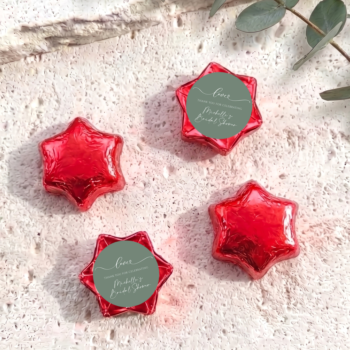 Foil-covered chocolate stars, red with round personalized label