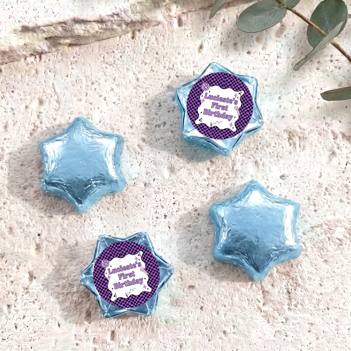 Foil-covered chocolate star candies in light blue with personalised 'Birthday' topper