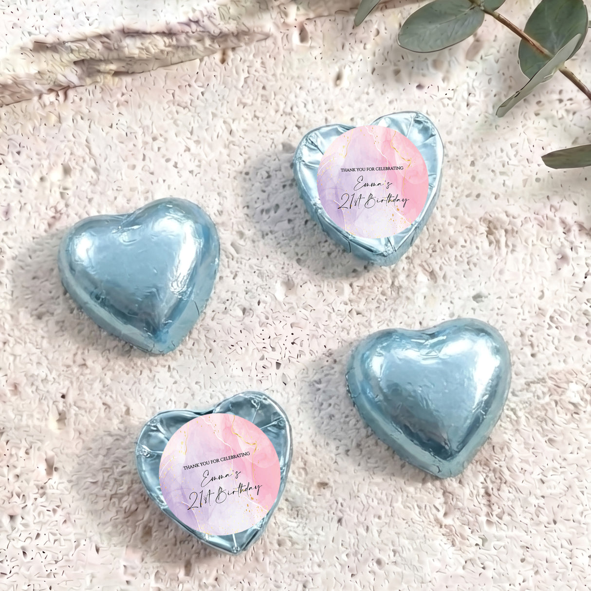 Foil-covered chocolate hearts, light blue heart-shaped chocolates with a round label on top