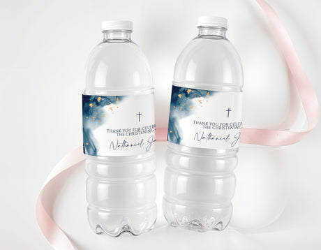 Two clear plastic water bottles with blue christening labels and gold accents
