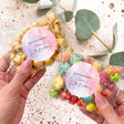 Kids birthday popcorn bag, clear wrap with multicolor popcorn, round purple personalized label