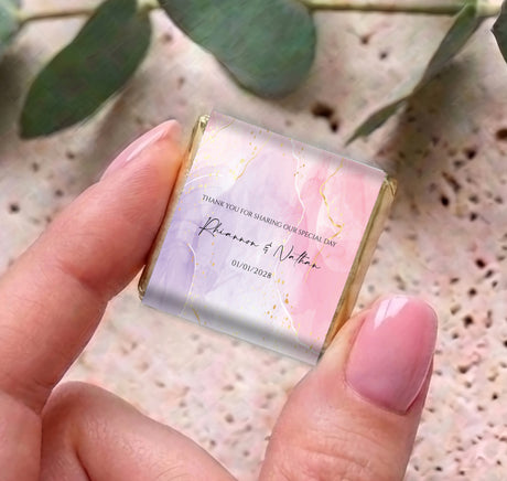 Pink & purple marble mini chocolates, personalised thank-you wrapper held in hand