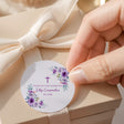 Round confirmation round label with purple roses, cross, and thank you text