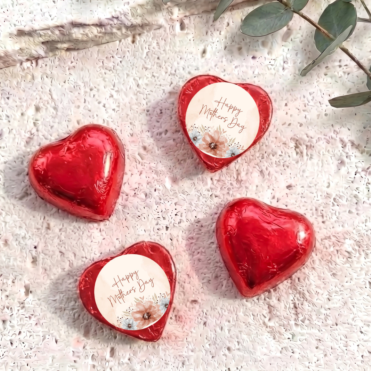 Red heart-shaped foil chocolate with “Happy Mother’s Day” floral message on white center