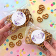 Personalised pretzel bag with clear wrapper and white floral seal label