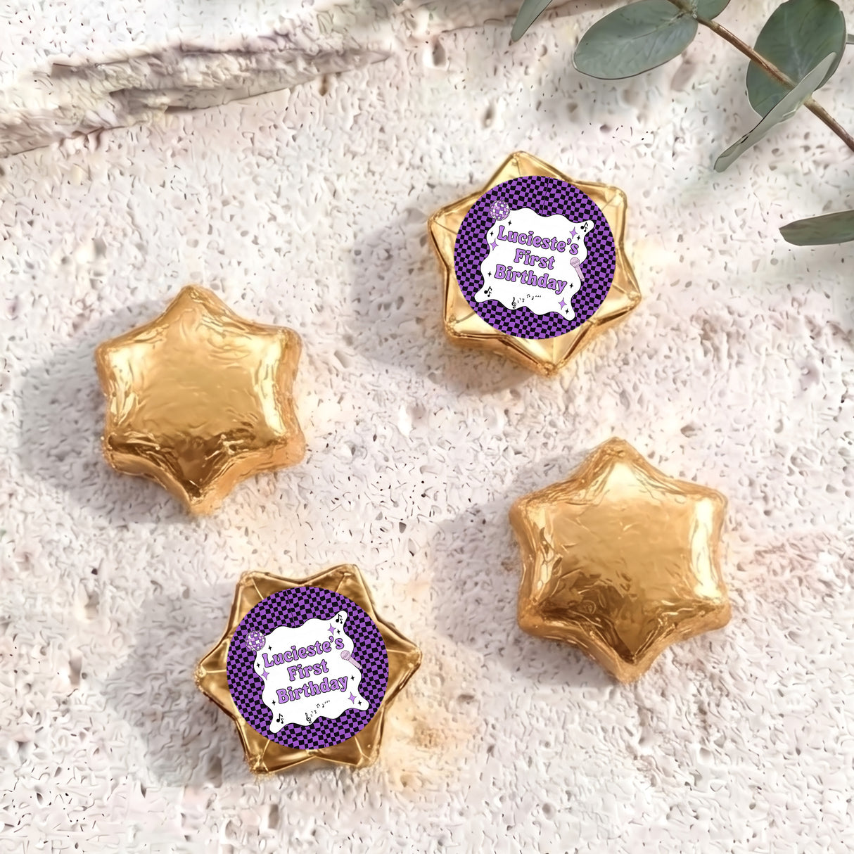 Foil-covered chocolate star candies in gold with personalised 'Birthday' topper