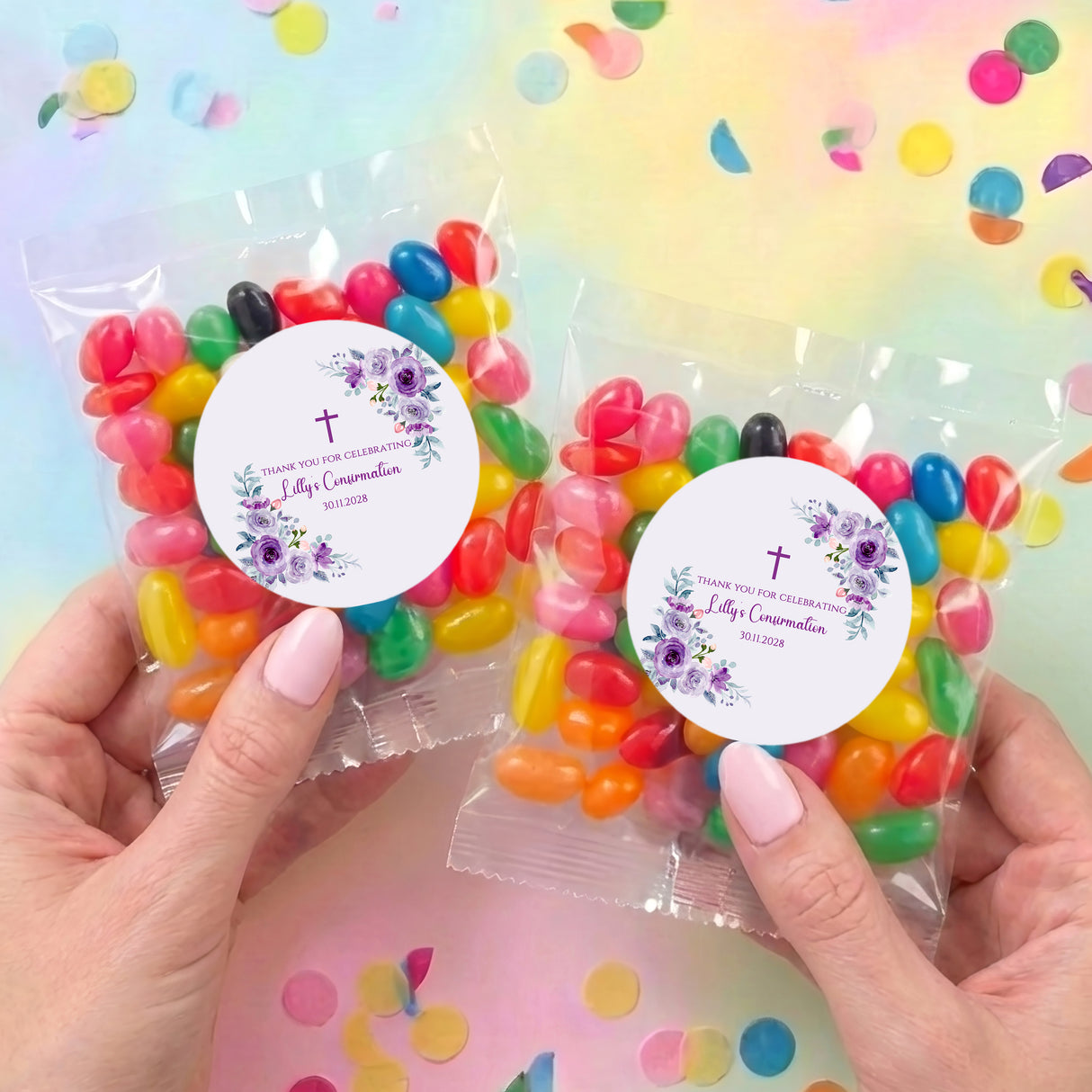 Two personalized confirmation jelly bean bags with round floral labels and mixed jelly beans