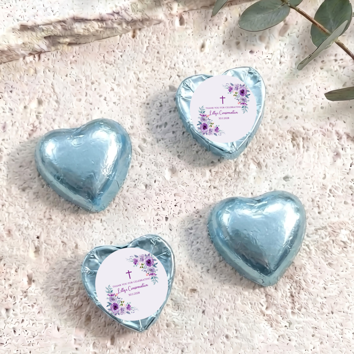 Foil-covered chocolate hearts, light blue with confirmation floral design on heart