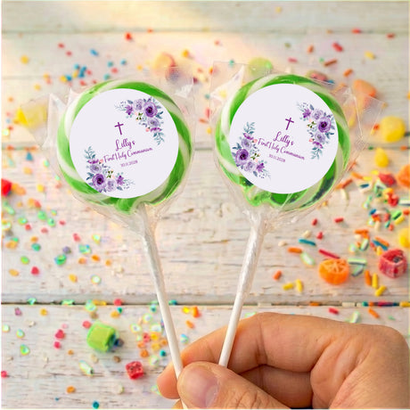 Green-wrapped personalised lollipops with purple rose First Holy Communion labels