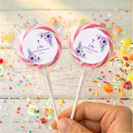 Pink-wrapped personalised lollipops with purple rose First Holy Communion labels