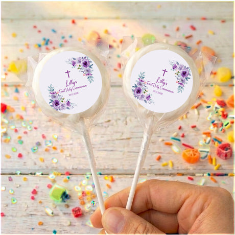 Clear-wrapped personalised lollipops with purple rose First Holy Communion labels
