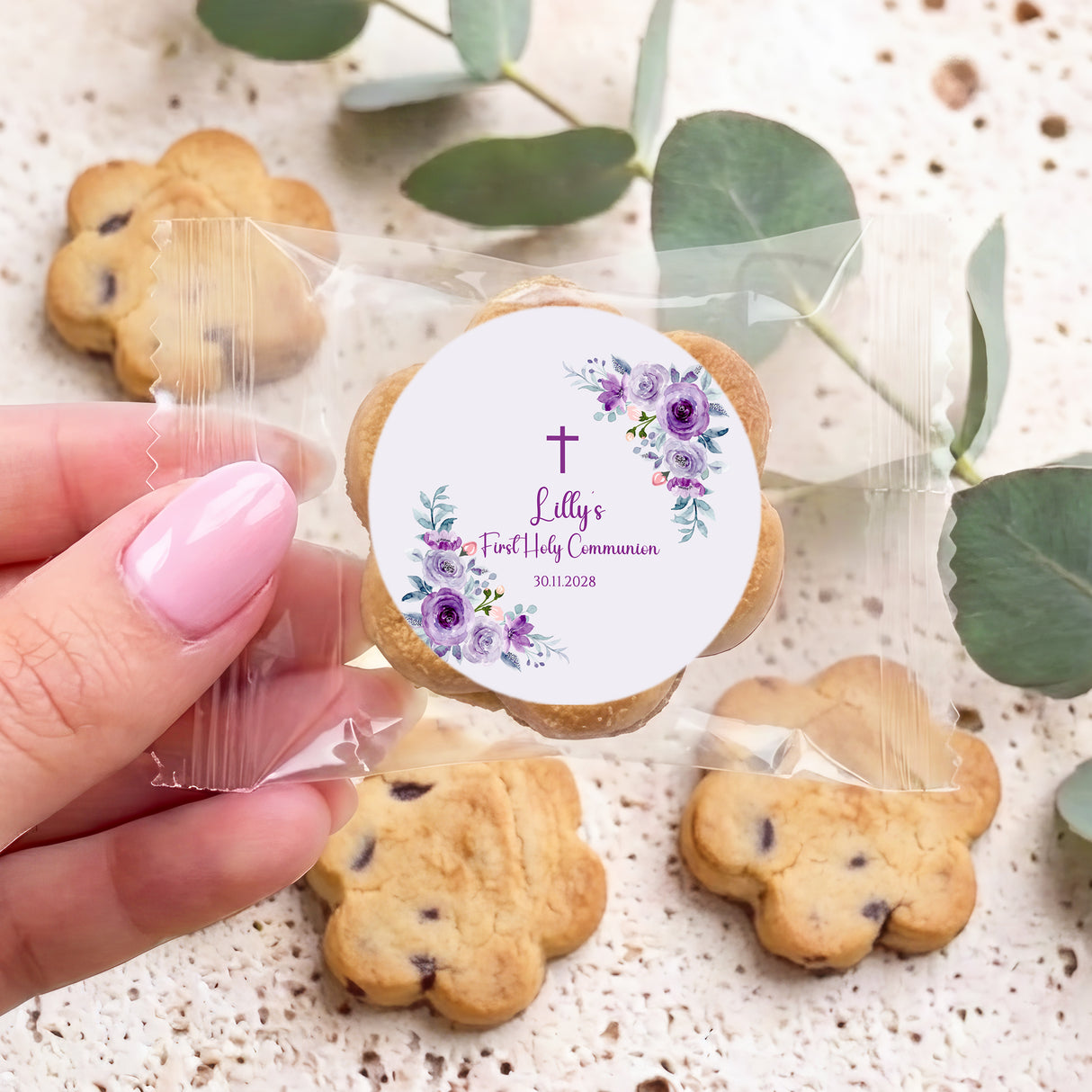 First Holy Communion cookies with purple rose round label and clear bag