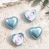 Foil-covered chocolate hearts with light blue finishes, floral cross message medallions