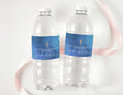 Two clear water bottles with ocean-blue baptism labels, gold cross, and thank-you text