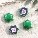 Foil-covered chocolate star candies in green with personalised 'Birthday' topper