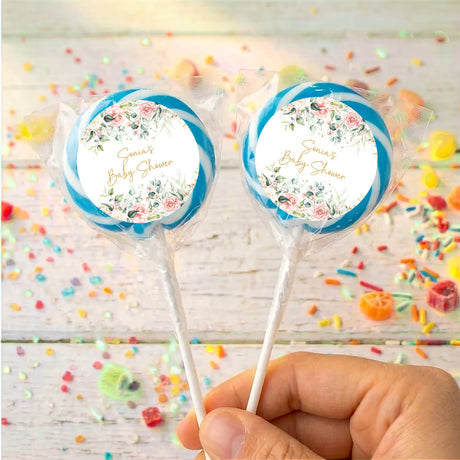 Personalised baby shower lollipops with blue circular labels and floral wreath design