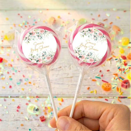 Personalised baby shower lollipops with pink circular labels and floral wreath design