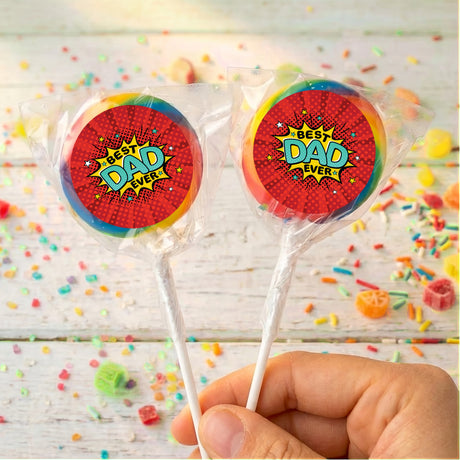 Hand holding two personalised lollipops with red 'Best Dad Ever' labels in clear wrappers