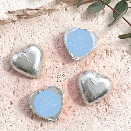 Silver foil heart chocolate favors with round blue personalised label