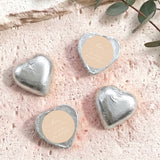 Silver foil-covered chocolate hearts with beige round labels and heart shapes