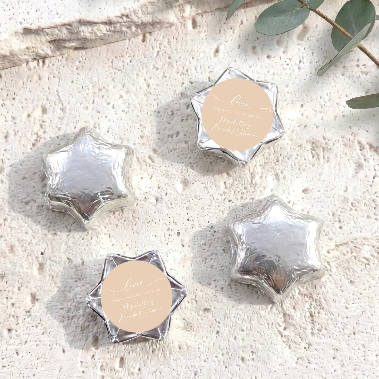 Foil-covered star chocolates with silver finish and round personalized tag
