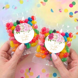 Two personalised jelly bean bags with pink rose round labels and multicolour candy in clear wrappers