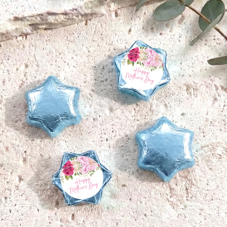 Foil-covered blue chocolate stars, one with floral 'Happy Mother's Day' label