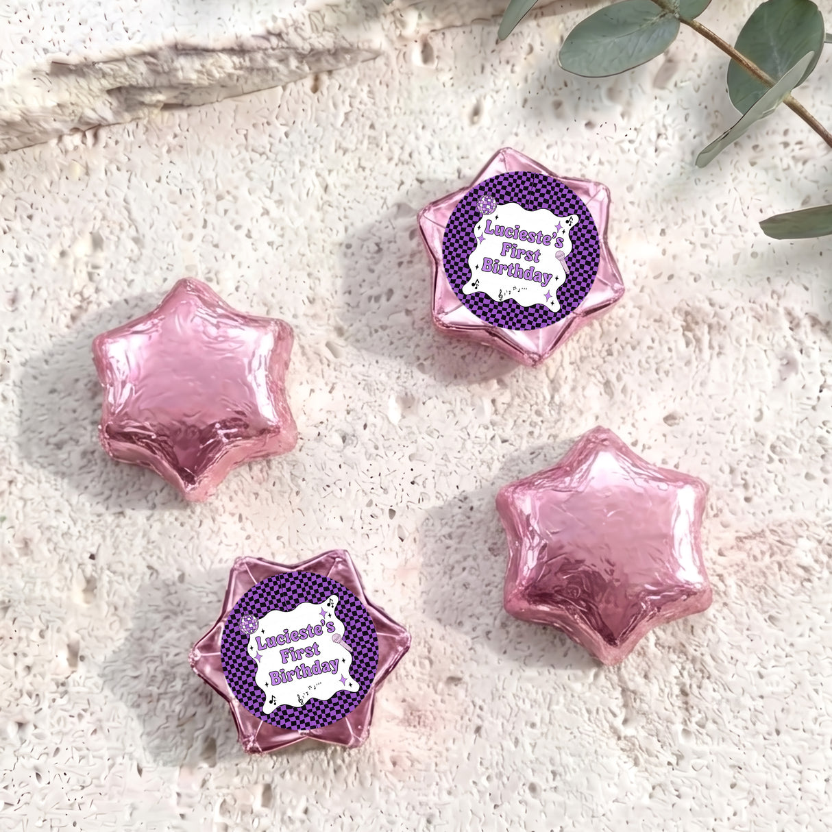 Foil-covered chocolate star candies in pink and purple with personalised 'Birthday' topper